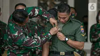 KSAD Jenderal TNI Andika Perkasa (kiri) memasangkan nama baru Aprilio Perkasa Manganang kepada Aprilia Manganang di Mabes AD, Jakarta, Jumat (19/3/2021). PN Tondano resmi mengabulkan permohonan pengubahan nama Aprilia Manganang menjadi Aprilio Perkasa Manganang. (Liputan6.com/Faizal Fanani)