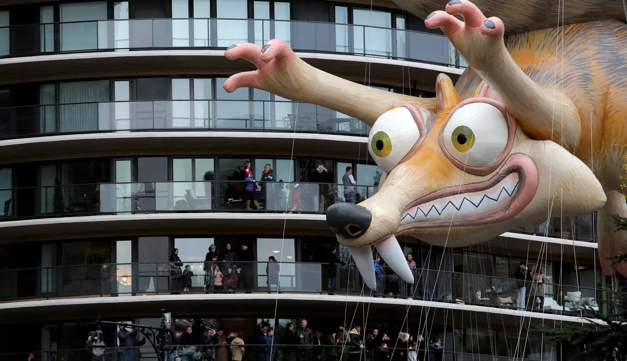 Balon animasi film Ice Age, Tupai Scrat melayang di dekat teras bangunan selama parade tahunan Macy's Thanksgiving Day ke-90 di Manhattan, New York, Kamis (24/11). Parade ini pertama kali diadakan oleh Macy's pada 1924 di New York. (REUTERS/Andrew Kelly)