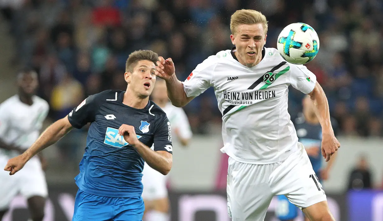 Bek Hannover 96, Timo Hubers (kanan) berebut bola dengan striker Hoffenheim, Andrej Kramaric pada pertandingan Bundesliga di Sinsheim, Jerman selatan pada 27 April 2018. Timo Hubers kini sedang dikarantina dan belum melakukan kontak langsung dengan pemain Hannover lainnya. (AFP/Daniel Roland)