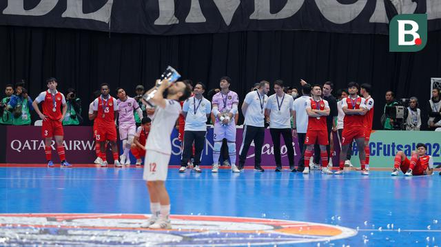 Para pemain Timnas Futsal Indonesia melihat pemain Timnas Iran mencium trofi kemenangan dalam Piala Asia Futsal 2026 yang berlangsung di Indonesia Arena, Senayan, Jakarta, Sabtu (07/02/2026). (Bola.com/Bagaskara Lazuardi)
