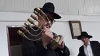 Rabi Yaakov Baruch memegang menorah di Sinagoge Shaar Hasyamayim, Tondano, Sulawesi Utara, Senin (4/3). Yaakov Baruch adalah rabi di satu-satunya sinagoge di Indonesia. (Ronny Adolof Buol/AFP)