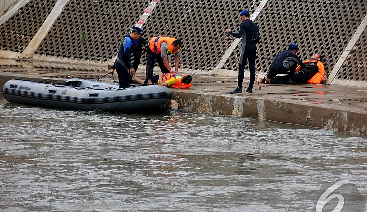 Petugas memberikan pertolongan pertama kepada warga yang hanyut dalam simulasi penyelamatan saat banjir, Kampung Pulo, Jakarta, Selasa (13/1/2015). (Liputan6.com/Johan Tallo)