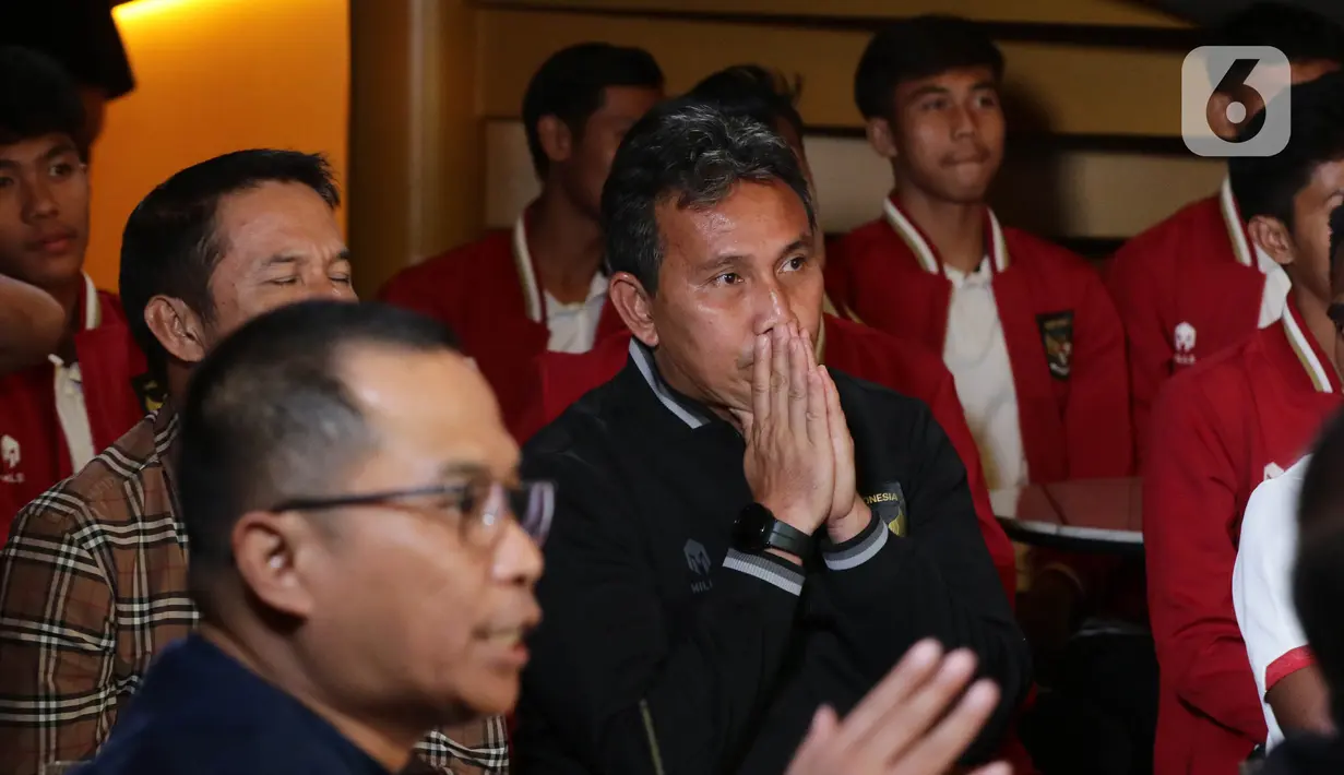 Ekspresi pelatih tim nasional Indonesia U-17, Bima Sakti saat menyaksikan tayangan acara pengundian pembagian grup Piala Dunia U-17 yang digelar Zurich, Swiss, Jumat (15/9/2023) malam. (Liputan6.com/Helmi Fithriansyah)