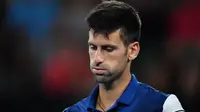 Ekspresi Novak Djokovic pada laga melawan Hyeon Chung di babak empat Australia Terbuka 2018, Senin (22/1/2018). (AFP/Paul Crock)