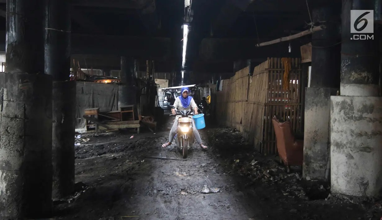 Warga beraktivitas di permukiman kolong Jalan Tol Pelabuhan, Tanjung Priok, Jakarta, Senin (23/4). Mahalnya harga hunian di Ibu Kota membuat mereka tinggal di kawasan tersebut meski dengan kondisi lingkungan kumuh dan kotor. (Liputan6.com/Arya Manggala)