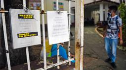 Seorang pria berjalan dekat pemberitahuan penutupan kantor Western Union di Havana, Kuba, Senin (23/11/2020). Layanan transfer uang terkemuka di dunia itu menutup lebih dari 400 gerainya di Kuba menyusul sanksi ekonomi terbaru yang dikeluarkan Amerika Serikat terhadap negara itu. (Yamil LAGE/AFP)