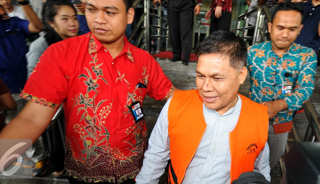 Adam Munandar berjalan menuju mobil tahanan usai menjalani pemeriksaan di gedung KPK , Jakarta, Jum'at (24/7/2015). Adam ditangkap bersama Kepala Dinas PPKAD, Syamsudin Fei dan Kepala Bappeda Kabupaten Muba Faisyar. (Liputan6.com/Yoppy Renato)