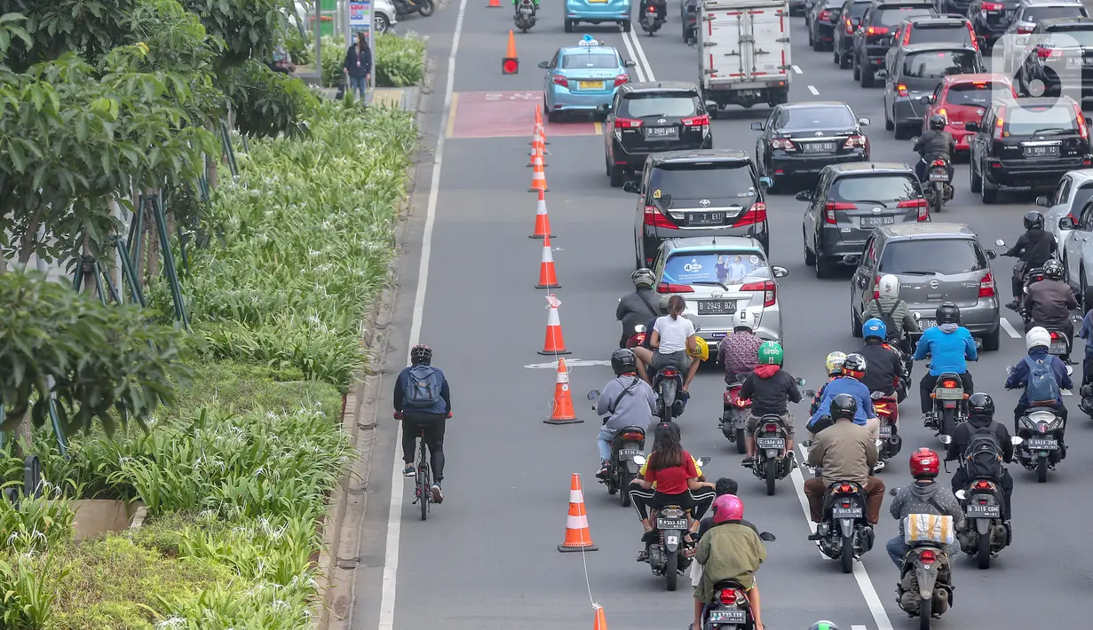 Warga bersepeda setelah jam kerja di jalur khusus sepeda kawasan Jalan Sudirman, Jakarta, Selasa (14/7/2020). Jam operasional dari Senin sampai Jumat pagi harinya jam 06.00 – 08.00 WIB, kemudian untuk sore dari jam 16.00 – 18.00 WIB. (Liputan6.com/Fery Pradolo)