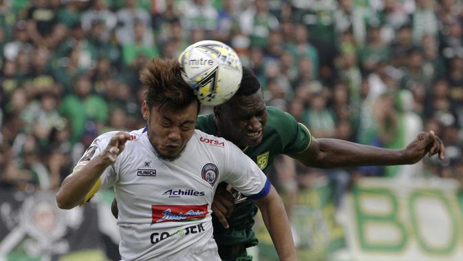 Bek Arema FC, Hamka Hamzah, berebut bola atas dengan striker Persebaya Surabaya, Amido Balde, pada laga final Piala Presiden 2019 di Stadion Gelora Bung Tomo, Surabaya, Selasa (9/4). Kedua tim bermain imbang 2-2. (Bola.com/Yoppy Renato)