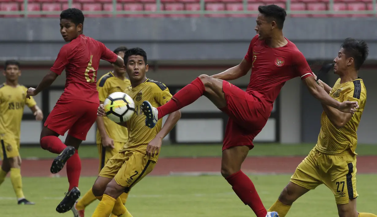 Bek Timnas Indonesia U-22, Andy Setyo, berusaha melepas tendangan saat melawan Bhayangkara FC pada laga uji coba di Stadion Patriot, Bekasi, Rabu (6/2). Keduanya bermain imbang 2-2. (Bola.com/Yoppy Renato)
