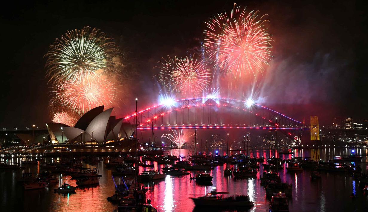 Cahaya kembang api menerangi langit di atas Jembatan Pelabuhan Sydney dan Gedung Opera Sydney, Australia, selama perayaan malam pergantian tahun, pada 1 Januari 2026. (Saeed KHAN/AFP)