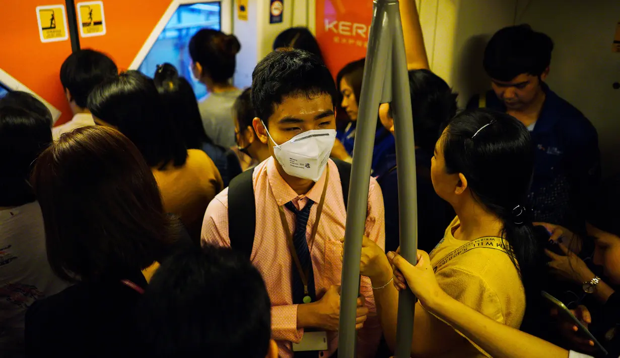 Seorang guru tunanetra, Damkerng Mungthanya menaiki skytrain di Bangkok, Thailand, 12 Februari 2019. Damkerng setiap hari berdesak-desakan di comuter untuk mencapai tempat kerjanya.  (REUTERS/Athit Perawongmetha)