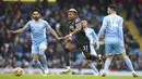 Pemain Wolverhampton Wanderers Adama Traore (tengah) berebut bola dengan pemain Manchester City Ilkay Gundogan (kiri) dan Aymeric Laporte pada pertandingan sepak bola Liga Inggris di Etihad Stadium, Manchester, Inggris, 11 Desember 2021. Manchester City menang 1-0. (AP Photo/Dave Thompson)