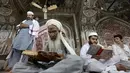 Sejumlah orang membaca AlQuran saat Ramadan hari pertama di Peshawar, Pakistan, Sabtu (27/5). Beragam ibadah dilakukan umat muslim untuk berlomba-lomba mencari pahala saat Ramadan. (AP Photo / Muhammad Sajjad)