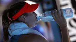 Petenis Rusia Maria Sharapova minum saat pertandingan putaran keempat melawan petenis Australia Ashleigh Barty di kejuaraan tenis Australia Terbuka di Melbourne, Australia(20/1). Sharapova kalah 4-6 6-1 6-4. (AP Photo/Mark Schiefelbein)