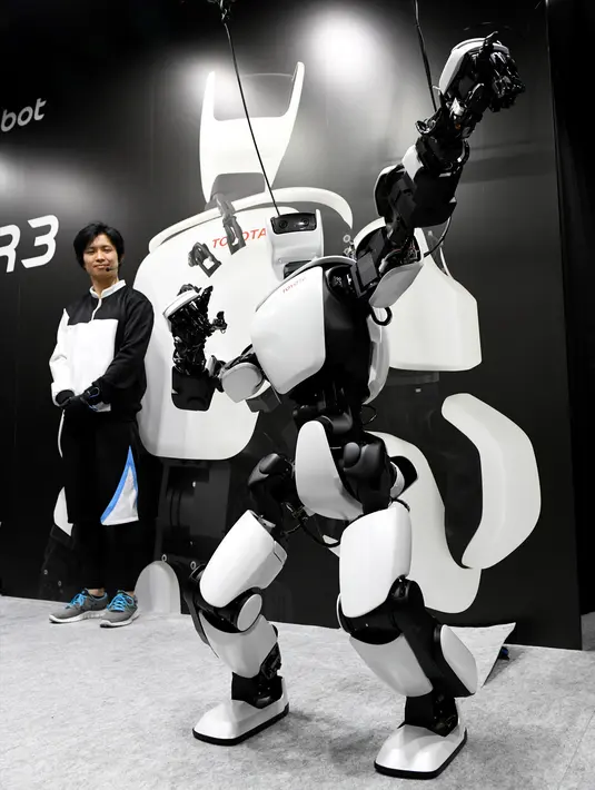 Robot humanoid generasi ketiga T-HR3 berpose saat Pameran Robot Internasional 2017 di Tokyo (29/11). Robot terbaru ciptaan Toyota ini dapat membantu manusia baik di rumah atau di tempat kerja. (AFP/Toru Yamanaka)