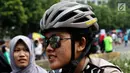 Seorang polisi wanita mengenakan helm dan kacamata berpatroli dengan sepeda di lokasi car free day, Jakarta, Minggu (21/5). (Liputan6.com/Immanuel Antonius)