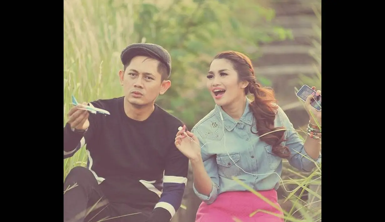 Dalam salah satu foto, Fitri Karlina tampak ceria berpose dengan Hendra yang tengah memegang miniatur pesawat. (instagram.com/fitricarlina)