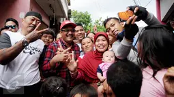 Cagub DKI Jakarta Djarot Saiful Hidayat foto bersama warga Rawa Terate, Jakarta, Kamis (12/1). Warga Terate berharap pasangan tersebut dapat meneruskan program-program yang selama ini telah berjalan untuk memajukan Jakarta. (Liputan6.com/Gempur M Surya)