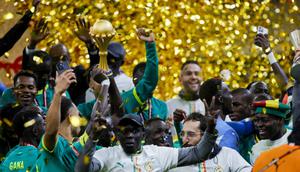 Para anggota tim Senegal merayakan kemenangan dengan trofi setelah memenangkan pertandingan final Piala Afrika (CAN) melawan Maroko di Stadion Pangeran Moulay Abdellah di Rabat pada 18 Januari 2026. (Abdel Majid BZIOUAT/AFP)