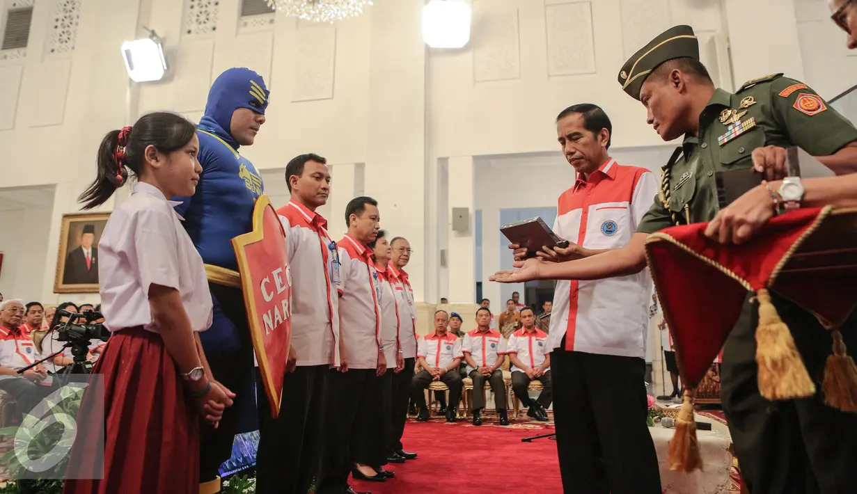 Presiden Joko Widodo memberikan penghargaan saat peringatan Hari Anti Narkoba Internasional di Istana Negara, Jumat (26/6/2015). Peringatan Hari Anti-Narkoba Internasional bertema “Kecanduan dapat dicegah dan disembuhkan”. (Liputan6.com/Faizal Fanani)