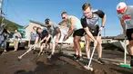 Para pemain rugby Kanada secara sukarela membersihkan jalan usai terjadi Topan Hagibis di Kamaishi, Prefektur Iwate, Jepang, Minggu (13/10/2019). Topan Hagibis membuat pertandingan Rugby World Cup Pool B antara Kanada dengan Namibia dibatalkan. (Kyodo News via AP)
