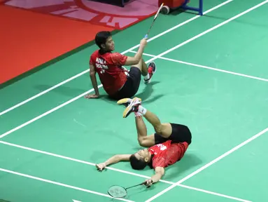 Ganda putra Indonesia, Ricky Karandasuwardi/Angga Pratama terjatuh saat melawan He Jiting/Tan Qiang (China) pada 32 besar Indonesia Open 2018 di Istora GBK, Jakarta, Rabu (4/7). Ricky/Angga unggul 16-21, 21-17, 26-24. (Liputan6.com/Helmi Fithriansyah)