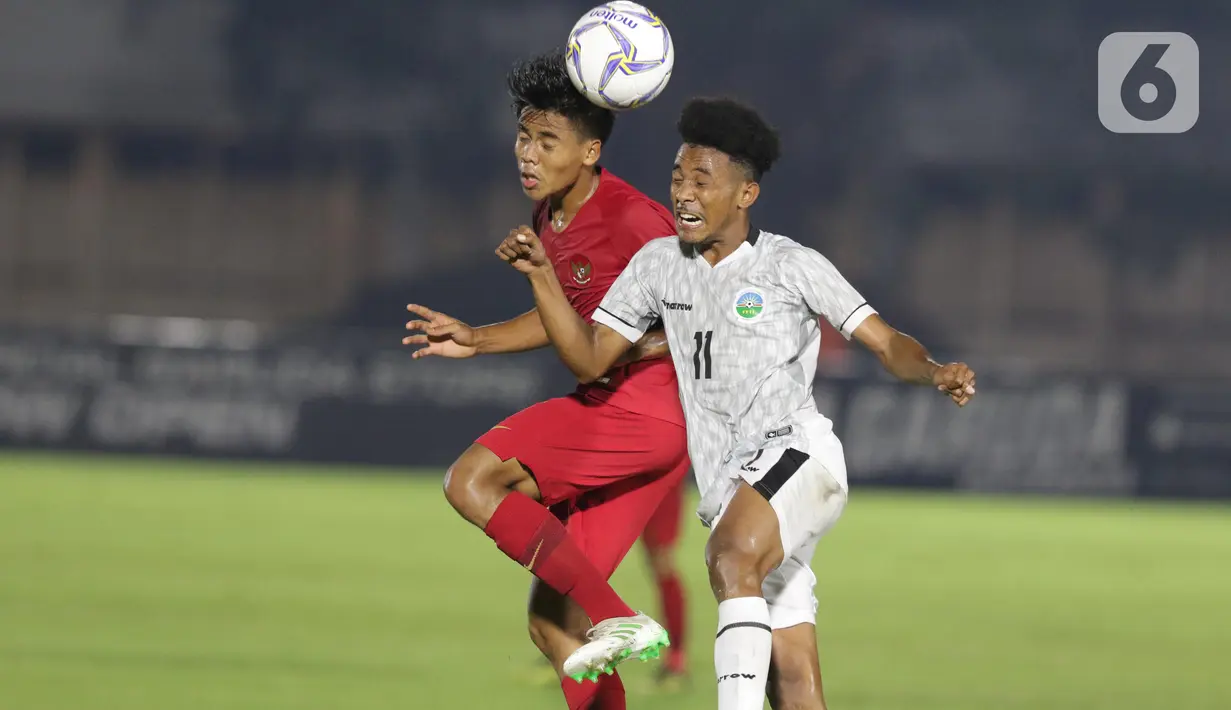 Pemain Timnas Indonesia U-19, David Maulana (kiri) berebut bola dengan pemain Timor Leste pada laga kualifikasi Grup K Piala AFC U-19 2020 di Stadion Madya Gelora Bung Karno, Jakarta, Rabu (6/11/2019). Indonesia unggul 3-1. (Liputan6.com/Helmi Fithriansyah)