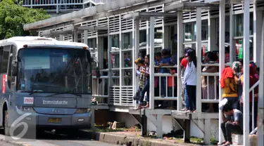 Penumpang tampak pada pintu tunggu masuk bus Transjakarta menuju Ragunan di Halte Dukuh Atas 2, Jakarta, Jumat (1/1/2016). Ratusan penumpang menumpuk menunggu bus TransJakarta tujuan Ragunan untuk menikmati libur panjang 2016. (Liputan6.com/Yoppy Renato)