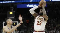 Aksi pemain Cleveland Cavaliers, LeBron James (23) melakukan tembakan melewati pemain Spurs, Danny Green (kiri) pada lanjutan NBA di basketball game di AT&T Center, San Antonio, (23/1/2018). Spurs menang 114—102. (AP/Eric Gay)