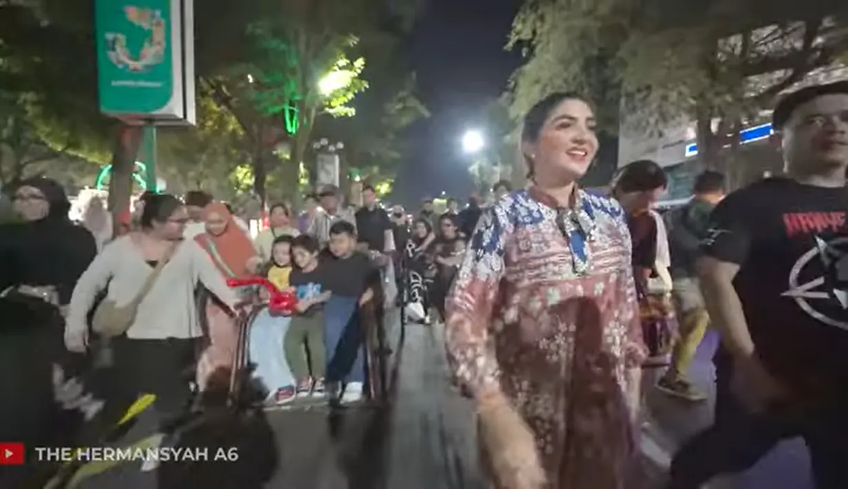 Suasana malam keluarga Ashanty saat menikmati jalan-jalan di alun-alun Jember. Tampak, Arsy dan Arsya juga begitu senang naik becak keliling. Kehadiran keluarga Anang dan Ashanty menarik perhatian pengunjung lain. [Youtube/The Hermansyah A6]