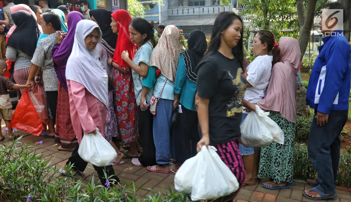 Dua wanita membawa paket sembako murah yang dijual oleh PT Asabri (Persero) di RPTRA Alur Dahlia, Tegal Alur, Jakarta Barat, Selasa (21/5/2019). Asabri menjual sebanyak 3 ribu sembako seharga Rp 10 ribu kepada masyarakat sekitar. (Liputan6.com/Johan Tallo)
