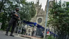 Polisi bersenjata melakukan pejagaan saat misa Minggu Paskah di Gereja Katedral, Jakarta, Minggu (4/4/2021). Sejumlah personel gabungan TNI-Polri disipakan untuk melakukan pengamanan di sejumlah gereja pada perayaan Paskah. (Liputan6.com/Faizal Fanani)