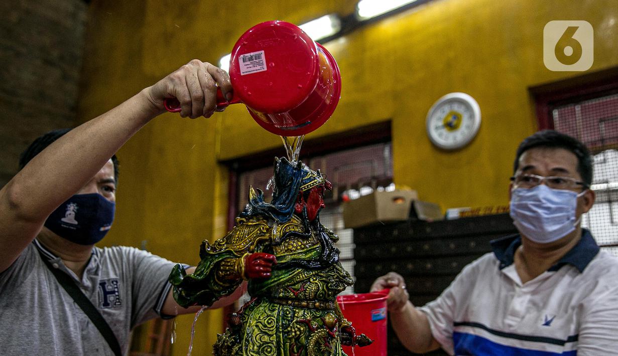Para jemaat membersihkan patung yang ada di Vihara Amurva Bhumi, Jakarta, Kamis (4/2/2021). Ritual mencuci patung dewa serta bersih-bersih ini dilakukan dalam rangka menyambut perayaan Tahun Baru Imlek 2572. (Liputan6.com/Faizal Fanani)