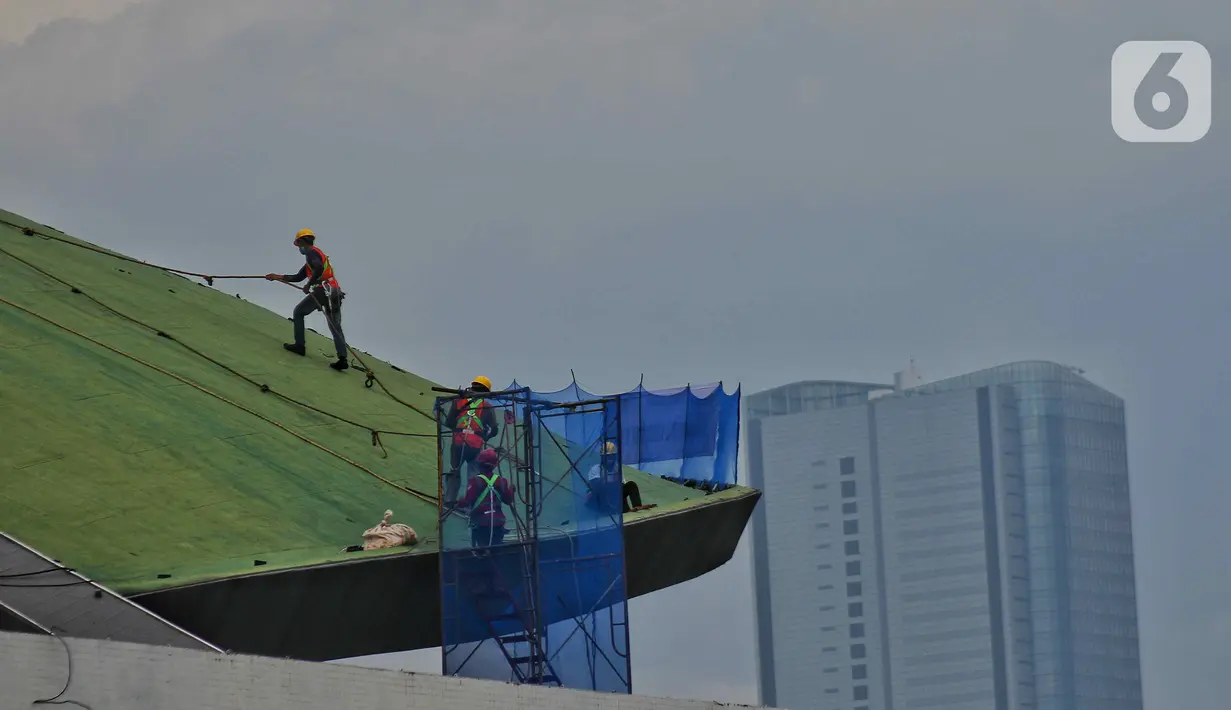 Pekerja menyelesaikan perawatan gedung kura-kura DPR RI di kompleks Parlemen Senayan, Jakarta, Senin (7/11/2022). Dengan tambahan 3,59 juta tersebut total penerima bantuan subsidi upah (BSU)  hingga tahap 7 cair kepada 12,8 juta pekerja. (Liputan6.com/Angga Yuniar)