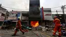 Petugas pemadam kebakaran melintas di depan ruko yang terbakar di Pasar Kebayoran Lama, Jakarta, Selasa (13/6). Kebakaran yang melanda ruko tersebut belum diketahui penyebabnya. (Liputan6.com/Johan Tallo)