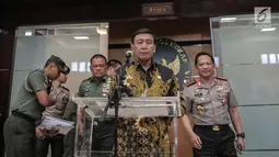 Menko Polhukam Wiranto (tengah) didampingi Panglima TNI Jenderal TNI Gatot Nurmantyo (kiri) dan Kapolri Jenderal Pol Tito Karnavian (kanan) bersiap memberi keterangan usai rapat di Kemenkopolhukam, Jakarta, Jumat (6/10). (Liputan6.com/Faizal Fanani)