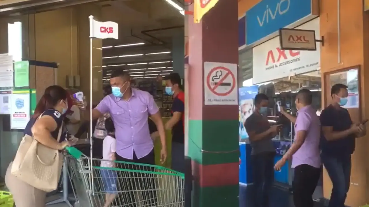 Seorang petugas keamanan periksa suhu tubuh pengunjung