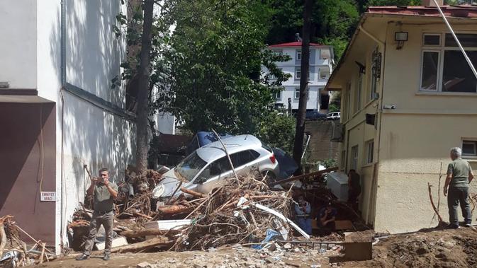 Orang-orang terlihat di area yang terdampak banjir di Provinsi Giresun, kawasan Laut Hitam, Turki (23/8/2020). Banjir yang melanda Giresun pada Minggu (23/8) menewaskan enam orang, termasuk dua personel Gendarmerie, demikian dilaporkan kantor berita semiresmi Turki Anadolu Agency. (Xinhua)
