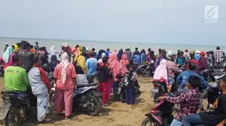 Warga berkerumun menantikan evakuasi pesawat Lion Air JT 610 di Pantai Pakis Jaya, Karawang, Jawa Barat, Senin (29/10). Lion Air JT 610 hilang kontak usai lepas landas dari Bandara Soetta saat menuju Pangkalpinang. (Liputan6.com/Herman Zakharia)