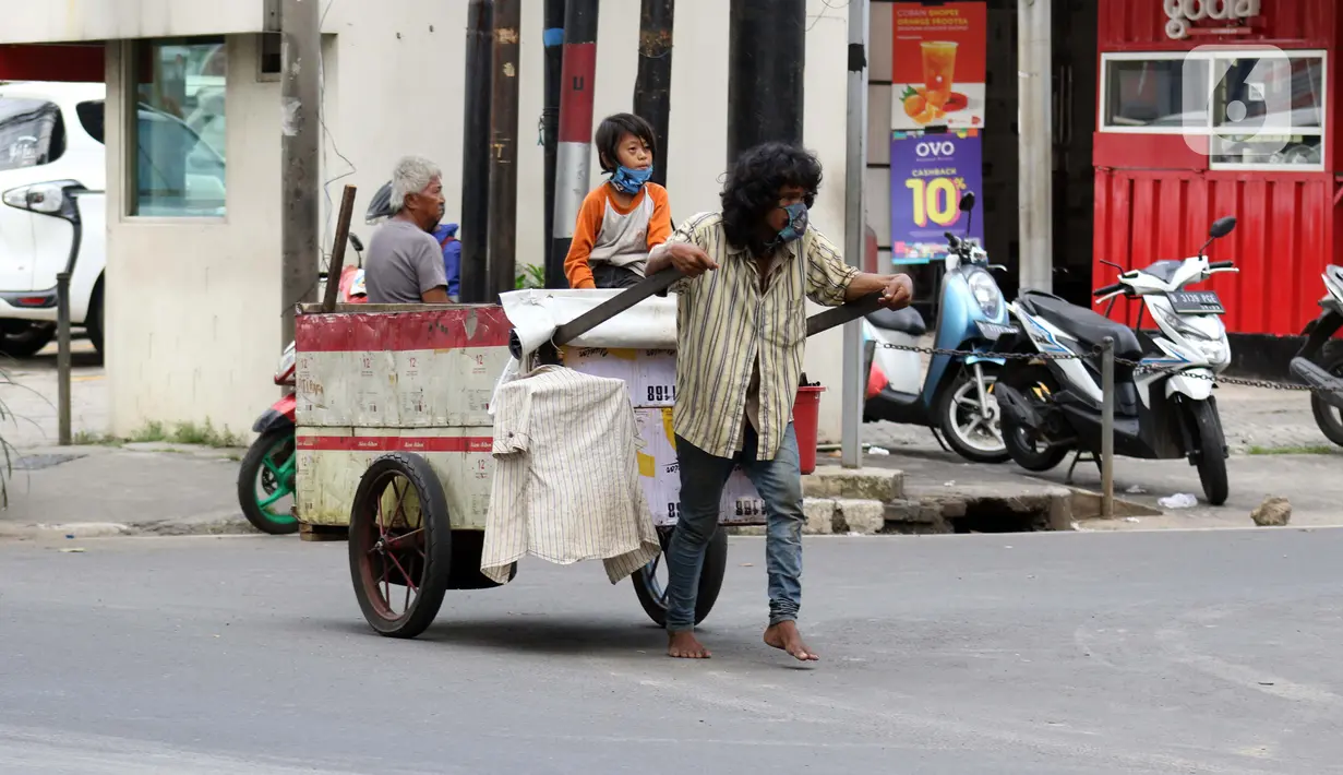 Pemulung melintas di Jalan Raden Saleh, Jakarta, Kamis (30/4/2020). Setiap Ramadan tiba, kemunculan pemulung yang membawa gerobak marak terjadi. Saat ini, kemunculan mereka menjadi masalah tersendiri di tengah upaya memutus mata rantai penyebaran Covid-19. (Liputan6.com/Helmi Fithriansyah)