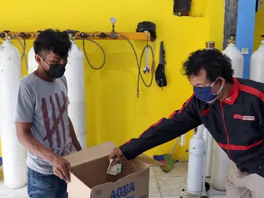 Warga membayar usai mengisi ulang oksigen di Fauzi Medical, Matraman, Jakarta Timur, Kamis (22/7/2021). Sebagai bentuk kepedulian terhadap sesama di tengah pandemi COVID-19, agen isi ulang oksigen tersebut menerapkan sistem pembayaran secara sukarela bagi warga. (Liputan6.com/Herman Zakharia)