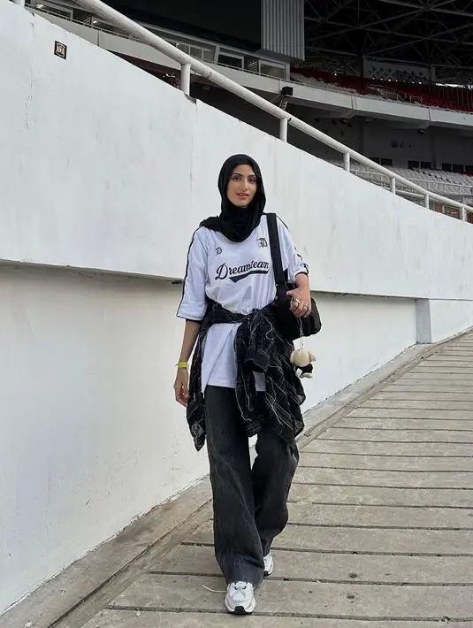 Boyish look untuk nonton konser memang selalu menarik. Bisa tiru gaya Munira Agile yang memadukan oversized jerseynya dengan baggy pants dan plaid shirt yang diikat di pinggang.[@miraagile].