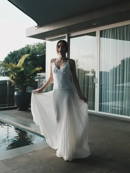 Gaun maxi dengan korset rajutan dan v-neck dan detail jahitan di bawah dada.  [@alyssadaguise]