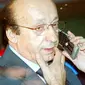 Juventus' general director Luciano Moggi phones as he leaves the San Nicola stadium in Bari after the Italian serie A football match Reggina vs Juventus, 14 May 2006. AFP PHOTO / GIULIO NAPOLITANO