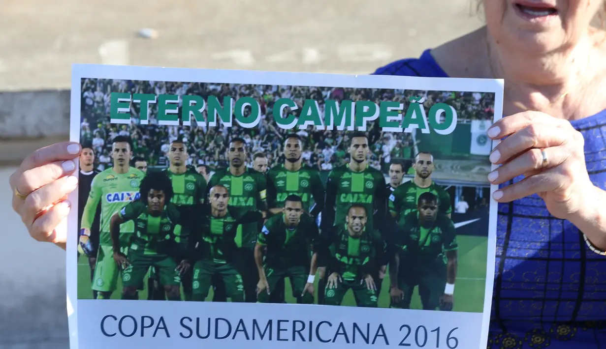 Fans Chapecoense menunjukkan poster timnya di stadion Arena Conda di Chapeco, Brasil, Selasa (29/11). Chapecoense mengadopsi warna hijau hijau untuk jersey utamanya sesuai dengan identitas kota mereka. (REUTERS / Paulo Whitaker)