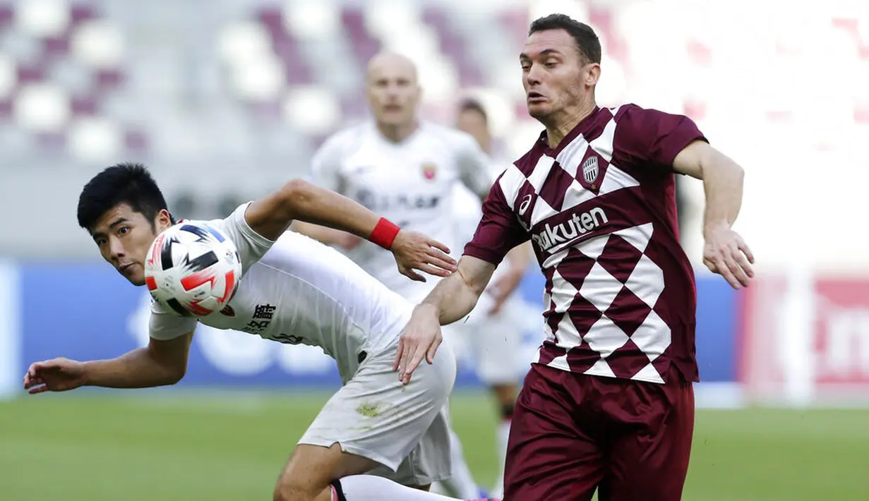 Pemain Shanghai SIPG, Li Shenglong, berebut bola dengan pemain Vissel Kobe, Thomas Vermaelen, pada laga Liga Champions Asia di Doha, Qatar, Senin (7/12/2/2020). Vissel Kobe menang dengan skor 2-0. (AP Photo/Hussein Sayed)