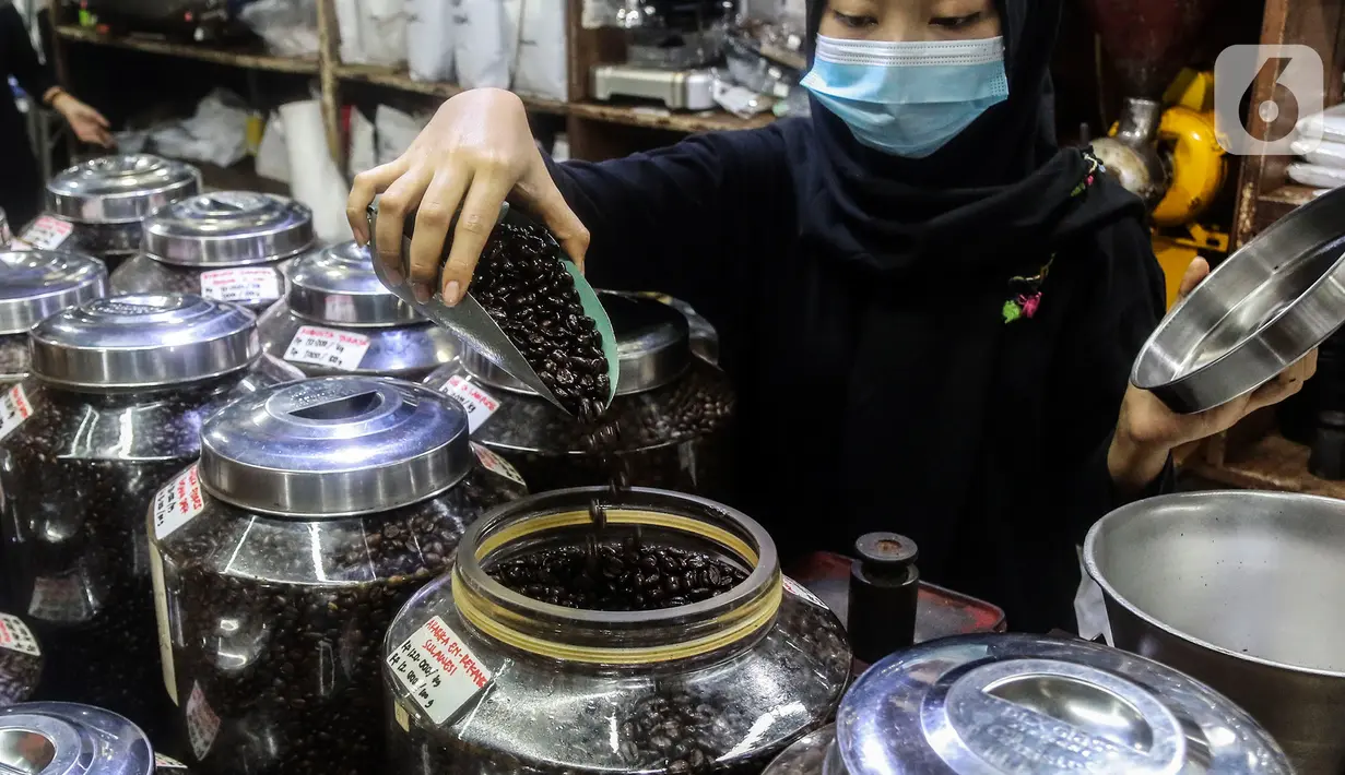 Pekerja memperlihatkan biji kopi dagangannya di salah satu gerai kopi di kawasan Jakarta, Rabu (24/3/2021). Tahun ini pemerintah menargetkan produksi kopi nasional sebesar 834.750 ton, naik dari tahun lalu sebanyak 769,7 ribu ton. (Liputan6.com/Johan Tallo)