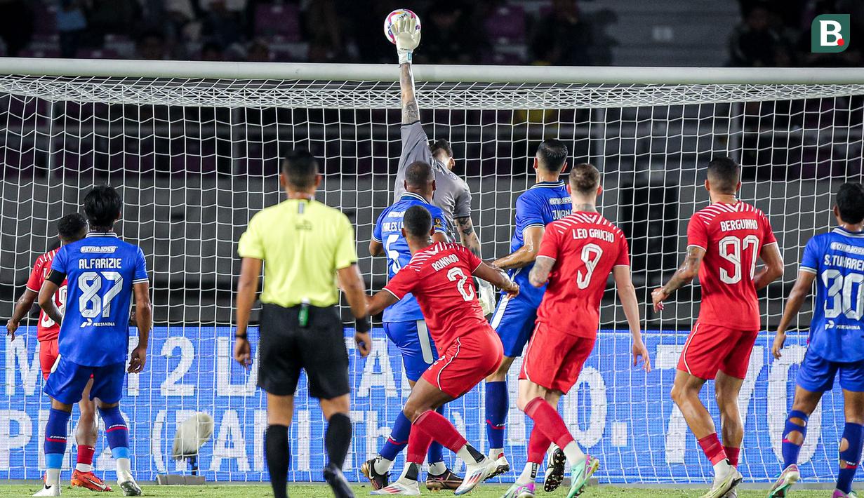 <p>Kiper Arema FC, Lucas Frigeri (tengah) melakukan penyelamatan saat menghadapi Borneo FC pada laga final Piala Presiden 2024 di Stadion Manahan, Solo, Minggu (4/8/2024). (Bola.com/Bagaskara Lazuardi)</p>