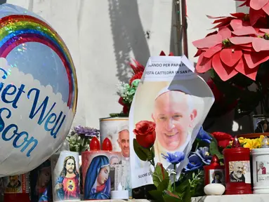 Balon-balon dipasang di patung Yohanes Paulus II di mana orang-orang datang untuk berdoa di luar rumah sakit Gemelli tempat Paus Fransiskus dirawat karena pneumonia, di Roma pada 23 Februari 2025. (Alberto PIZZOLI/AFP)